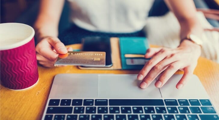 Closeup of a woman checking her credit card account with her bank online.