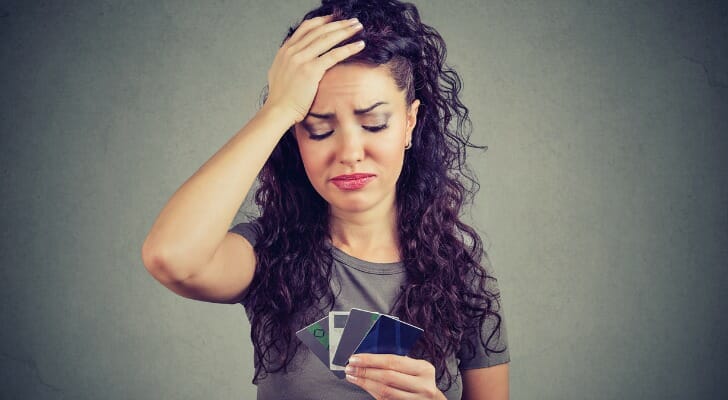 A woman trying to decide between bank cards.