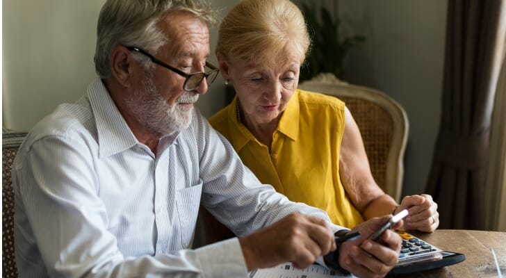 A senior couple reviewing a budget for their retirement plan.