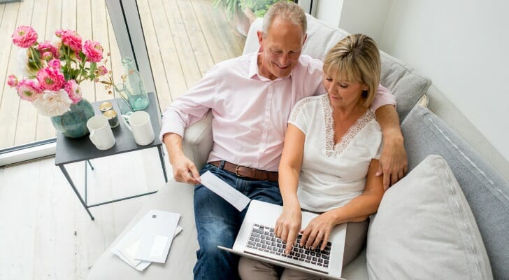 A couple reviews their bank account.