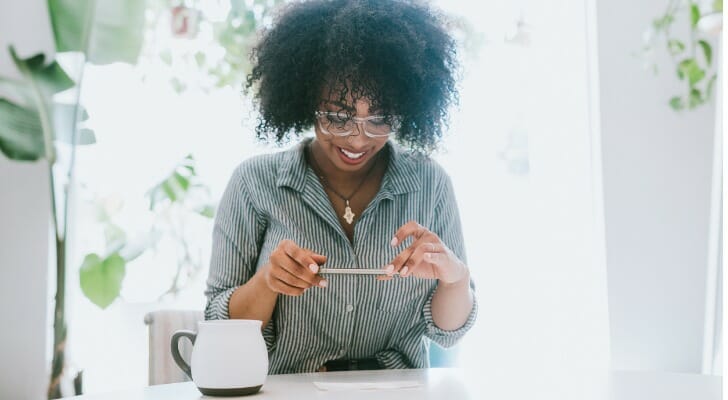 A woman depositing a check with a mobile bank app.