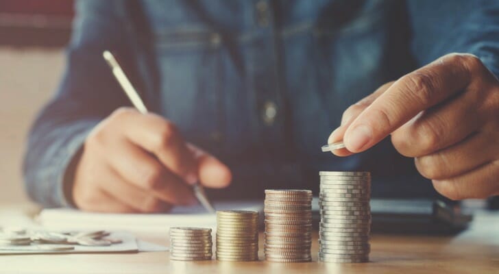 A man stacking loose change.