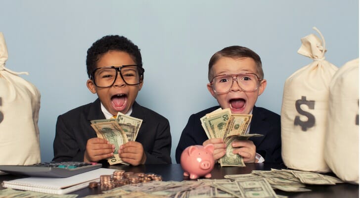 Two young boys excitedly counting money.