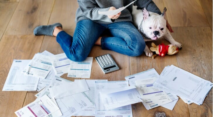 A woman looking over bank statements.