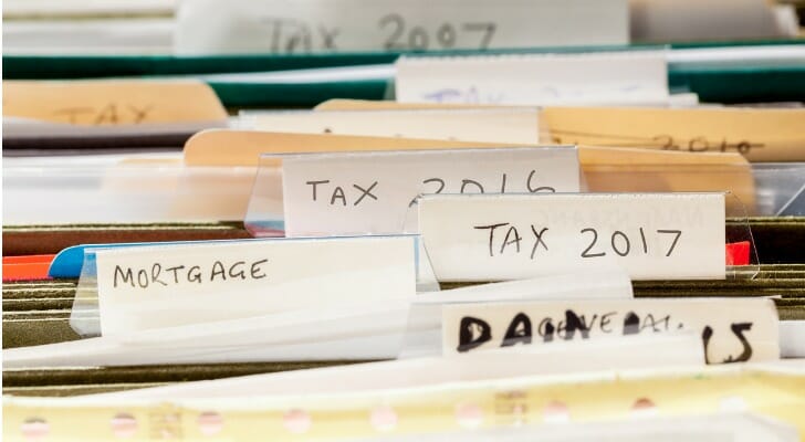 A filing cabinet with different tax, mortgage, and bank statements.