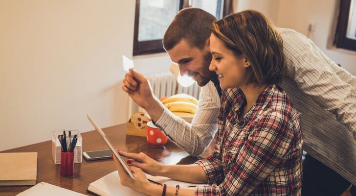 A couple open a bank account online.