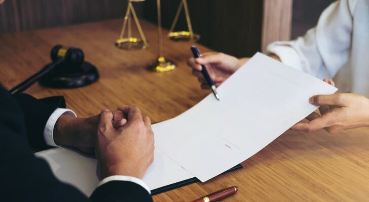 A lawyer reviews divorce laws in Texas with their client.