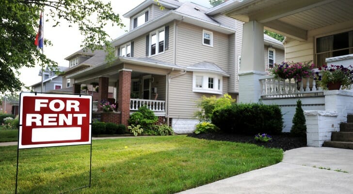 A "For Rent" sign in front of a property rental.