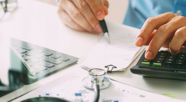 A man fills out Form 8889 to report an HSA rollover.