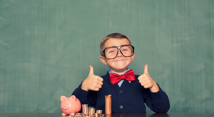 A young boy poses with his savings.