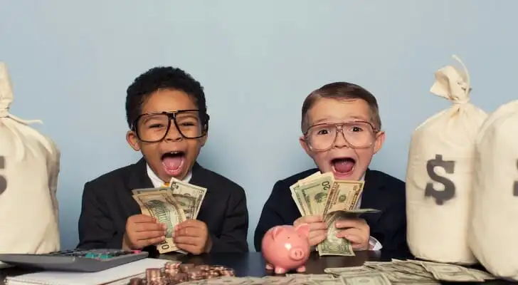 Kids sitting in between money bags holding up cash, symbolizing the growth of savings with interest.