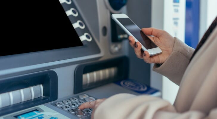 Closeup of a woman at an ATM.