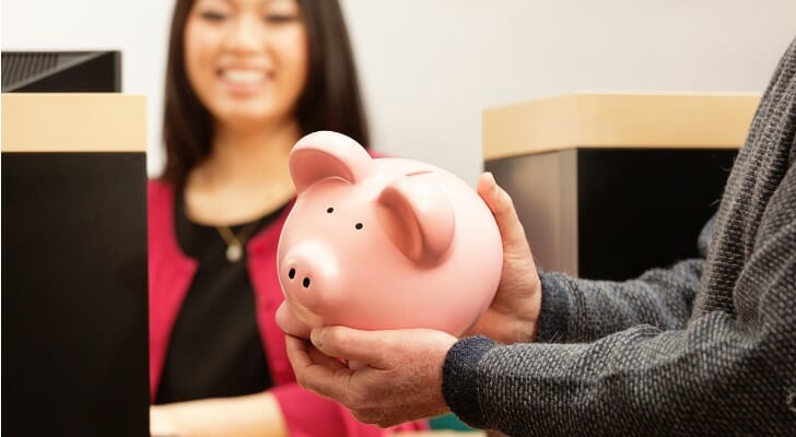 A man holding a piggy bank.