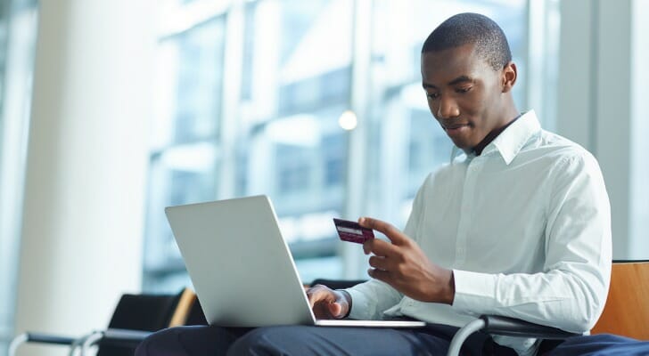 A man signing up for an online bank account.