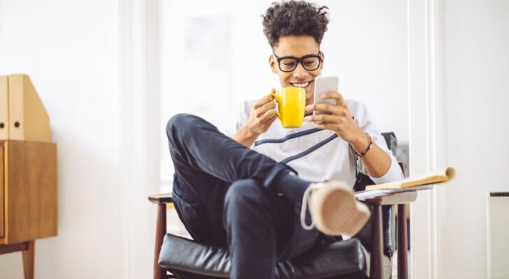 A man comparing bank apps on his mobile phone.