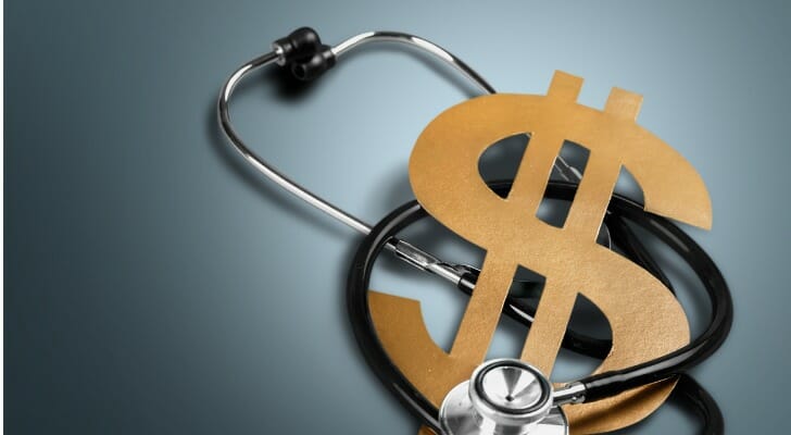A stethoscope wrapping around a dollar sign.