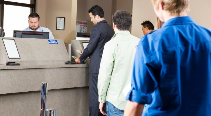A group of people in line at the bank before Black Friday.
