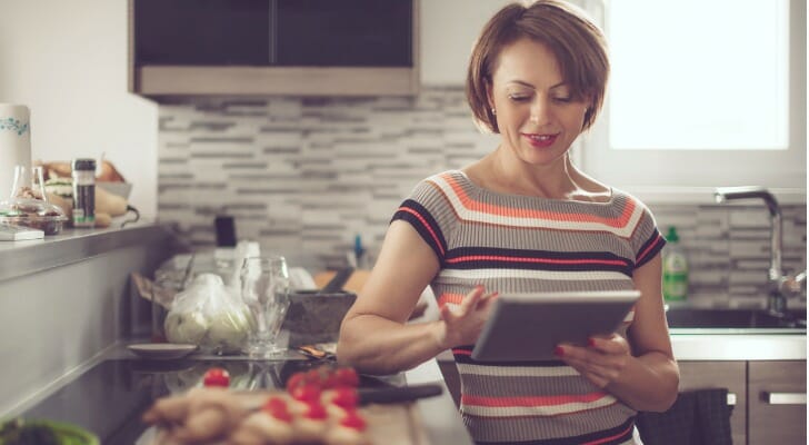 A woman evaluating services from Marcus by Goldman Sachs and Ally Bank.