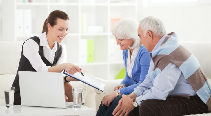 A couple discuss an annuity vs. IRA with their advisor.
