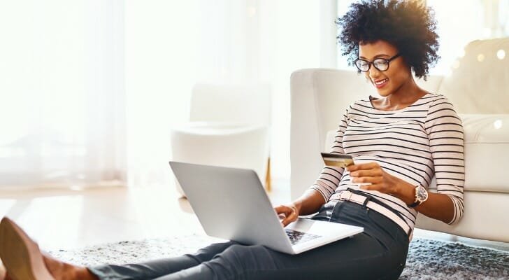 A woman comparing Ally Bank vs. Chase account options.