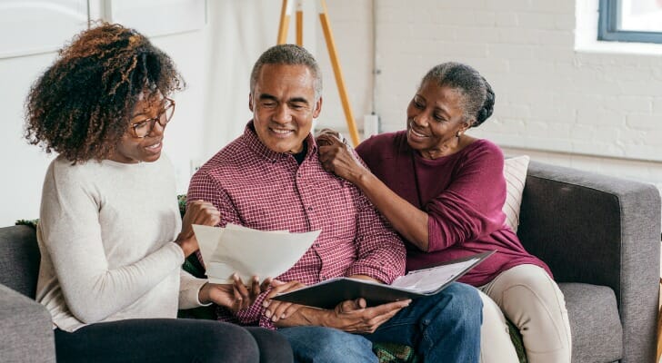 A couple setting up a trust fund with their advisor.