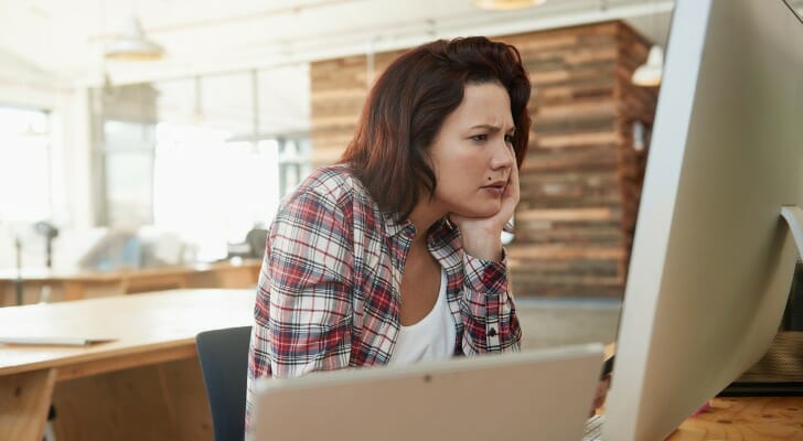 A woman compares Ally vs Barclays.