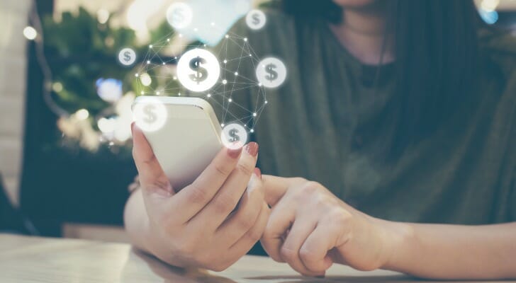 A woman checking her bank account on a phone app.