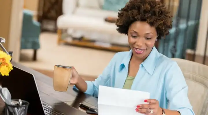 A woman reviews her bank statement.