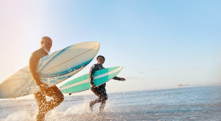 Two surfers prepare to catch some waves.