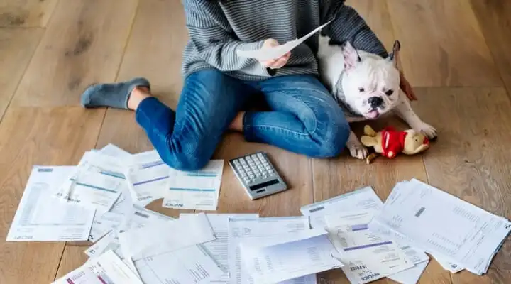 A woman organizes her bank statements, having learned how to get a bank statement.