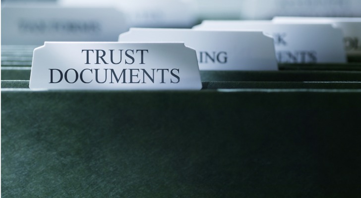 A folder marked "Trust Documents" appears in front of other filing cabinet folders.