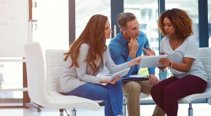 A couple review Executor of Estate vs. Power Of Attorney documents with their advisor.