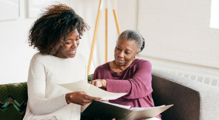 A mother and daughter review documents for Executor of Estate vs. Power Of Attorney.