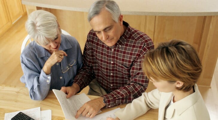 A couple review Executor of Estate vs. Power Of Attorney documents with an advisor.