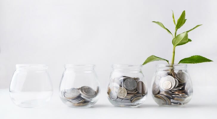 Jars filled with a gradually increasing amount of coins.
