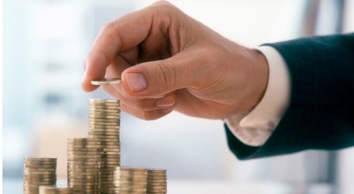 A man stacking coins.