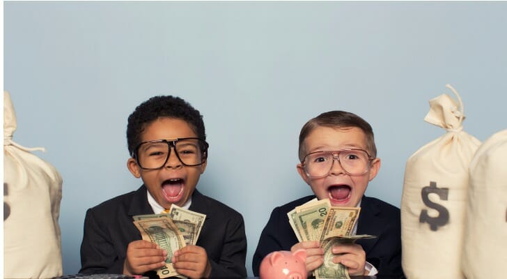 Two children hold money.