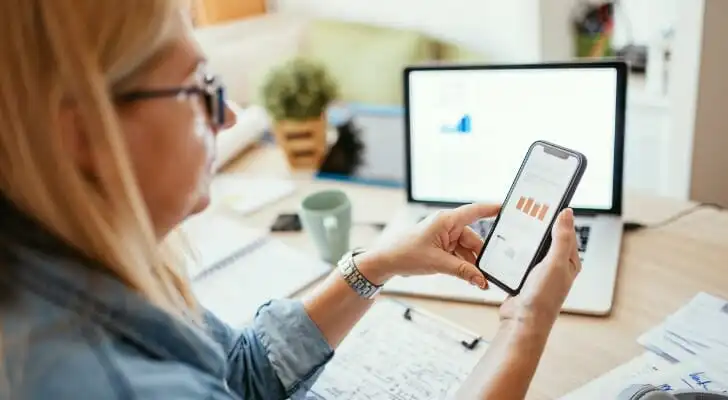 A financial planner checks her own accounts.