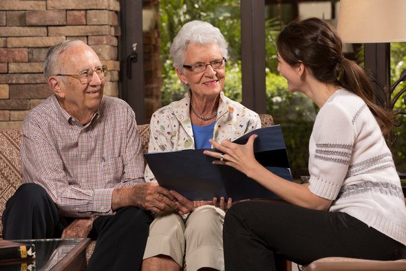 A couple review options for a gold IRA with their financial advisor.