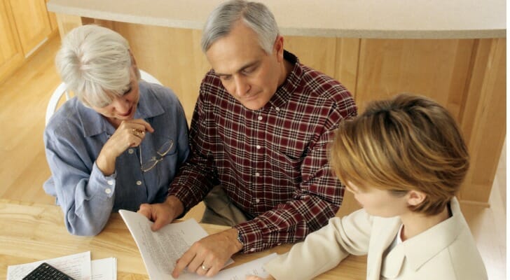A couple review documents with their estate planning attorney.