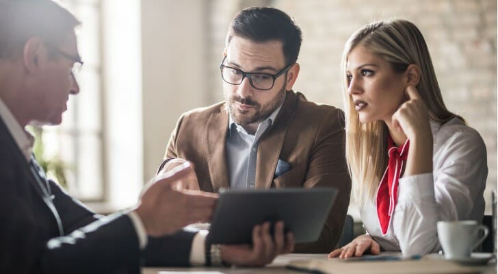 A couple speaking with their advisor to learn if indexed universal life insurance is a good fit for them.