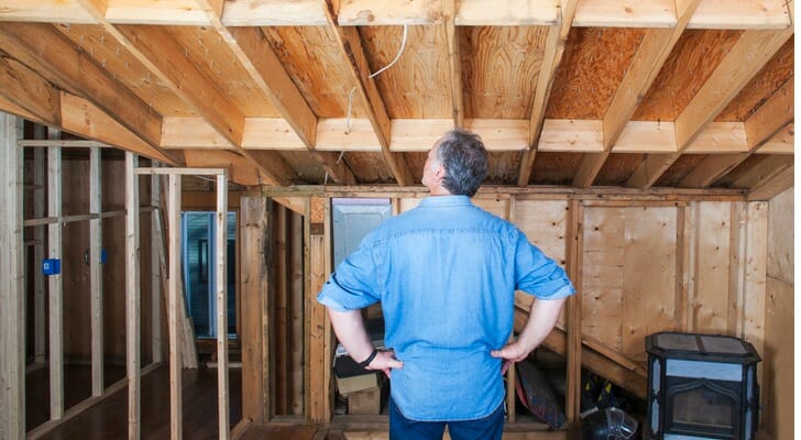 An inspector examining the beams of a house.