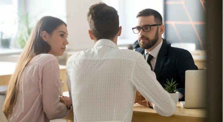 Investors meeting with a financial advisor to review their investment portfolio.