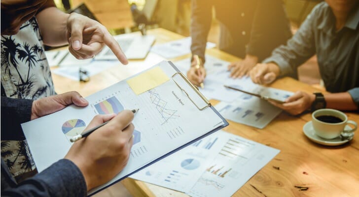 A group of advisors review their investment portfolios.