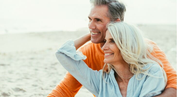 A husband and wife enjoy retirement, having chosen between a 403(b) vs. Roth IRA.