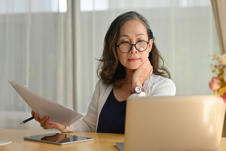 A woman reviewing her retirement portfolio after speaking with a financial advisor.