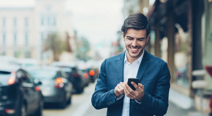 Happy man looking over his investment portfolio