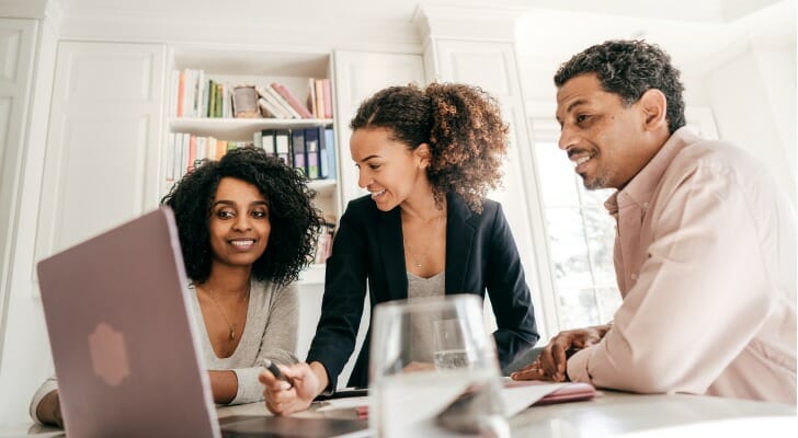A financial advisor shows clients how an amortization table works.