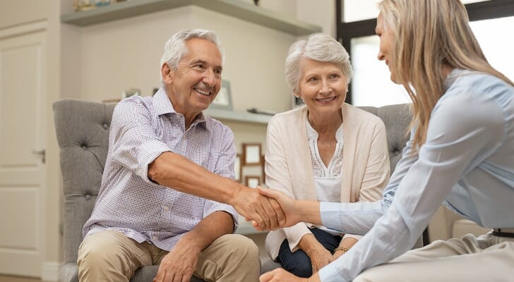 A couple sit down with their advisor to discuss Roth IRA withdrawal rules and penalties.