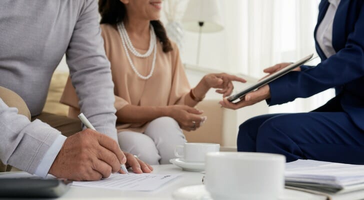A couple meet with a financial advisor to build their own plan for and definition of retirement.